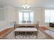 Bright dining room with a chandelier, a large window, and a wooden table at 10529 Sablewood Dr # 116, Raleigh, NC 27617