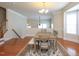Spacious dining room with hardwood floors and an open staircase view, great for entertaining at 10529 Sablewood Dr # 116, Raleigh, NC 27617