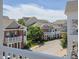 Exterior view of townhomes with well-maintained landscaping, viewed from a balcony at 10529 Sablewood Dr # 116, Raleigh, NC 27617