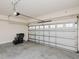 Spacious garage featuring a large door with window panels and room for multiple cars or storage at 10529 Sablewood Dr # 116, Raleigh, NC 27617
