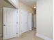 Hallway view with neutral carpet leading to multiple bedrooms and a laundry area at 10529 Sablewood Dr # 116, Raleigh, NC 27617