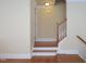 Inviting hallway showcases hardwood floors and staircase, leading to the upper level at 10529 Sablewood Dr # 116, Raleigh, NC 27617