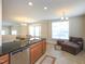 Open floor plan with a kitchen island that flows into a bright living area and breakfast nook at 10529 Sablewood Dr # 116, Raleigh, NC 27617