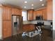 Beautiful kitchen with stainless steel appliances, wood cabinets, and sleek countertops at 10529 Sablewood Dr # 116, Raleigh, NC 27617