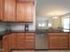 Bright kitchen features stainless steel dishwasher and a seamless transition to the adjacent living area at 10529 Sablewood Dr # 116, Raleigh, NC 27617