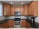 Well-lit kitchen features stainless steel appliances, ample cabinetry, and dark granite countertops at 10529 Sablewood Dr # 116, Raleigh, NC 27617