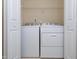 Open view of a laundry area with a white washer and dryer set at 10529 Sablewood Dr # 116, Raleigh, NC 27617
