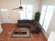 Open living room with hardwood floors, fireplace, high ceiling, and an inviting sectional couch at 10529 Sablewood Dr # 116, Raleigh, NC 27617