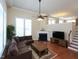 Spacious living room featuring a fireplace, hardwood floors, large windows, and comfortable seating at 10529 Sablewood Dr # 116, Raleigh, NC 27617