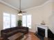Bright living room with a cozy fireplace, large windows, hardwood floors, and stylish furnishings at 10529 Sablewood Dr # 116, Raleigh, NC 27617