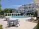 Community pool featuring abundant lounge chairs and tables with an inviting pergola at 10529 Sablewood Dr # 116, Raleigh, NC 27617