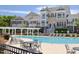 Community pool with lounge chairs, tables, and a pergola, perfect for relaxation and socialization at 10529 Sablewood Dr # 116, Raleigh, NC 27617