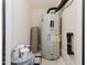 View of a utility room with a water heater, paint cans, and a rug at 10529 Sablewood Dr # 116, Raleigh, NC 27617