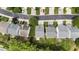 Drone view of houses with gray roofs, green lawns, and tree-lined neighborhood at 107 Caraleigh Ct, Morrisville, NC 27560