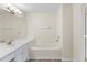 Bathroom featuring a single sink vanity, vanity mirror and built in bathtub at 107 Caraleigh Ct, Morrisville, NC 27560