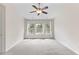 Large bright bedroom featuring a ceiling fan and natural light from the window at 107 Caraleigh Ct, Morrisville, NC 27560