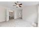 Carpeted bedroom with view to bathroom featuring ceiling fan, and natural light at 107 Caraleigh Ct, Morrisville, NC 27560