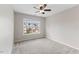 Bright bedroom featuring neutral walls, carpet, and a large window at 107 Caraleigh Ct, Morrisville, NC 27560