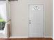 Bright and airy front door with decorative window, complemented by hardwood floors and natural light at 107 Caraleigh Ct, Morrisville, NC 27560