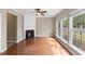 Bright living room with fireplace, ceiling fan, and large windows overlooking backyard at 107 Caraleigh Ct, Morrisville, NC 27560