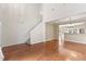 Open-concept living space highlighting hardwood floors, neutral colors, and a staircase to the upper level at 107 Caraleigh Ct, Morrisville, NC 27560