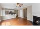 Open-concept living room with fireplace, adjoining kitchen with stainless steel appliances, and hardwood floors at 107 Caraleigh Ct, Morrisville, NC 27560
