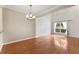 Bright living room with hardwood floors, chandelier, and large window for natural light at 107 Caraleigh Ct, Morrisville, NC 27560