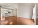Spacious living room featuring hardwood floors, neutral paint, and an open layout to the kitchen at 107 Caraleigh Ct, Morrisville, NC 27560