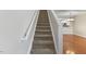Carpeted stairway with white handrail and trim leading to the second floor at 107 Caraleigh Ct, Morrisville, NC 27560