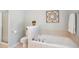 Bathroom features a soaking tub, shower, and neutral tile at 1102 Whiston Dr, Apex, NC 27502