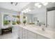 Bright bathroom featuring double sinks, large mirror, and natural light at 1102 Whiston Dr, Apex, NC 27502