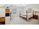 Bright bedroom features neutral carpet, large window, four poster bed, and a storage unit and desk at 1102 Whiston Dr, Apex, NC 27502