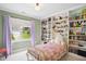 Charming bedroom with built-in bookshelves and soft natural light at 1102 Whiston Dr, Apex, NC 27502