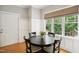 Cozy dining area features wood floors, natural light, and modern wall paneling at 1102 Whiston Dr, Apex, NC 27502
