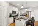 Bright kitchen features stainless appliances, an island with seating, and sleek countertops at 1102 Whiston Dr, Apex, NC 27502