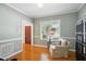 Inviting living room featuring hardwood floors, soft green walls and a white armchair at 1102 Whiston Dr, Apex, NC 27502