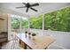 Inviting screened porch features wood table, seating for four, ceiling fan, and beautiful views of the wooded backyard at 1102 Whiston Dr, Apex, NC 27502