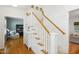 Bright entryway featuring a staircase with wood handrail, white risers and painted wood-paneled walls at 1102 Whiston Dr, Apex, NC 27502