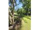 Expansive backyard with manicured lawn, shade trees, and colorful flowerbeds at 1157 S Cambridge Cir, Rocky Mount, NC 27801