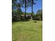 Spacious backyard with well-maintained lawn and mature trees offering ample shade at 1157 S Cambridge Cir, Rocky Mount, NC 27801