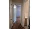 Hallway with hardwood floors leads to a bedroom and bathroom at 1157 S Cambridge Cir, Rocky Mount, NC 27801