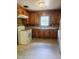 Traditional kitchen featuring wood cabinets, a white electric stove, and a double basin sink at 1157 S Cambridge Cir, Rocky Mount, NC 27801