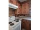 Close-up of kitchen showcasing wood cabinetry, white appliances, and laminate countertops at 1157 S Cambridge Cir, Rocky Mount, NC 27801