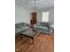 Cozy living room featuring hardwood floors, patterned couches, and overhead chandelier at 1157 S Cambridge Cir, Rocky Mount, NC 27801