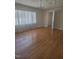 Bright and airy living room with hardwood floors, large window, and simple chandelier at 1157 S Cambridge Cir, Rocky Mount, NC 27801