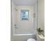 Bright bathroom with white subway tile, chrome fixtures, and a window overlooking the trees at 116 Lumpkin St, Raleigh, NC 27610