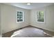 A bright bedroom with laminate flooring and two windows at 116 Lumpkin St, Raleigh, NC 27610