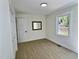 Light filled bedroom boasts stylish laminate flooring and large window view at 116 Lumpkin St, Raleigh, NC 27610