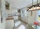 Well-lit kitchen with white cabinets, butcher block counters, decorative shelves, and trendy light fixture at 116 Lumpkin St, Raleigh, NC 27610