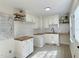 Bright kitchen features white cabinets, butcher block countertops, subway tile, and wood look floors at 116 Lumpkin St, Raleigh, NC 27610